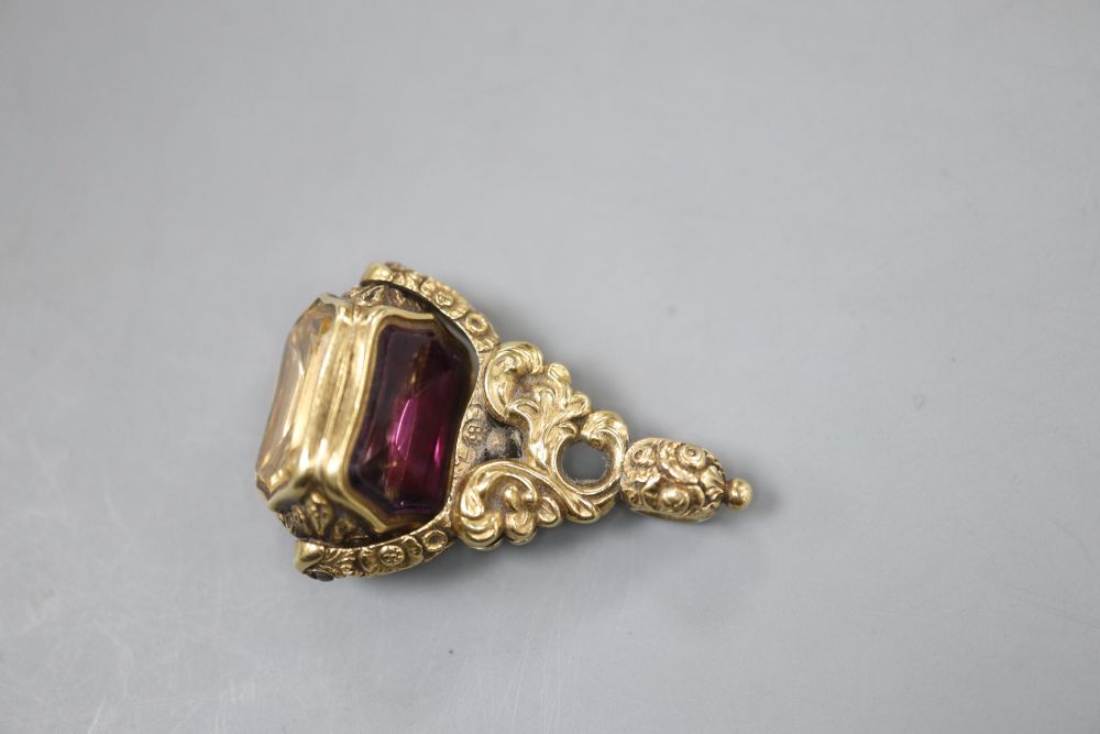 A Victorian yellow metal overlaid swivel triple gem set fob seal, with carved carnelian matrix, 37mm.